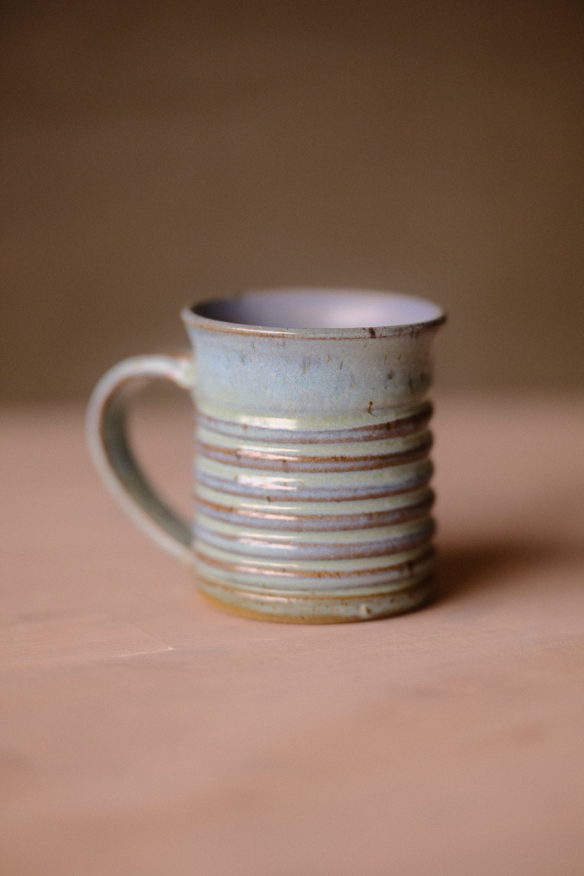 Secret Cenote Little Mug with horizontal ridges, standing on a tabletop with handle positioned to the left.