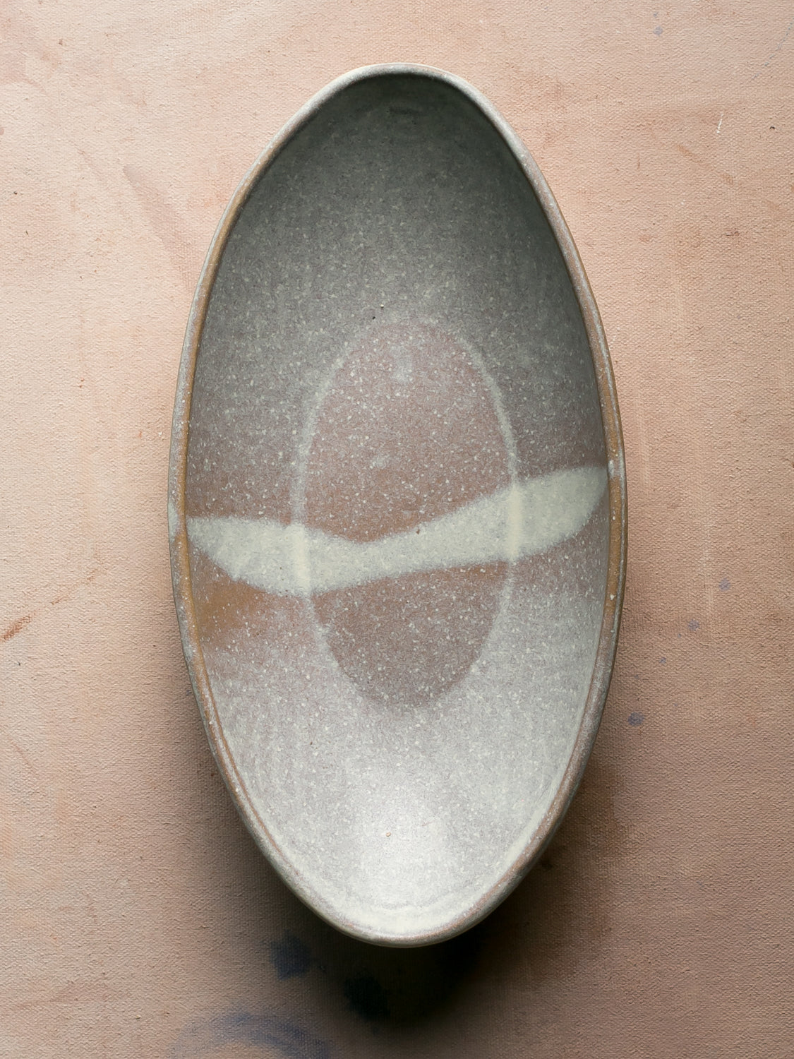 Wander Oval Server, overhead shot of glazed stoneware dish with pale band across center.