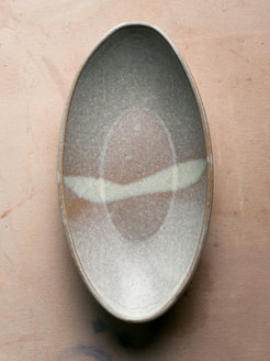 Wander Oval Server, overhead shot of glazed stoneware dish with pale band across center.