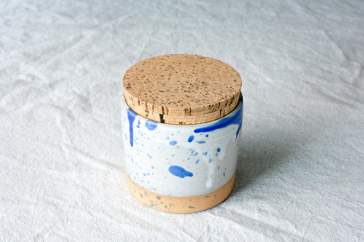 Wander Salt Jar in blue paint splatter and drip glaze over white ceramic with fitted cork.