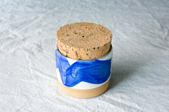 Wander Salt Jar featuring a bold blue brushstroke glaze pattern over white ceramic with cork stopper.
