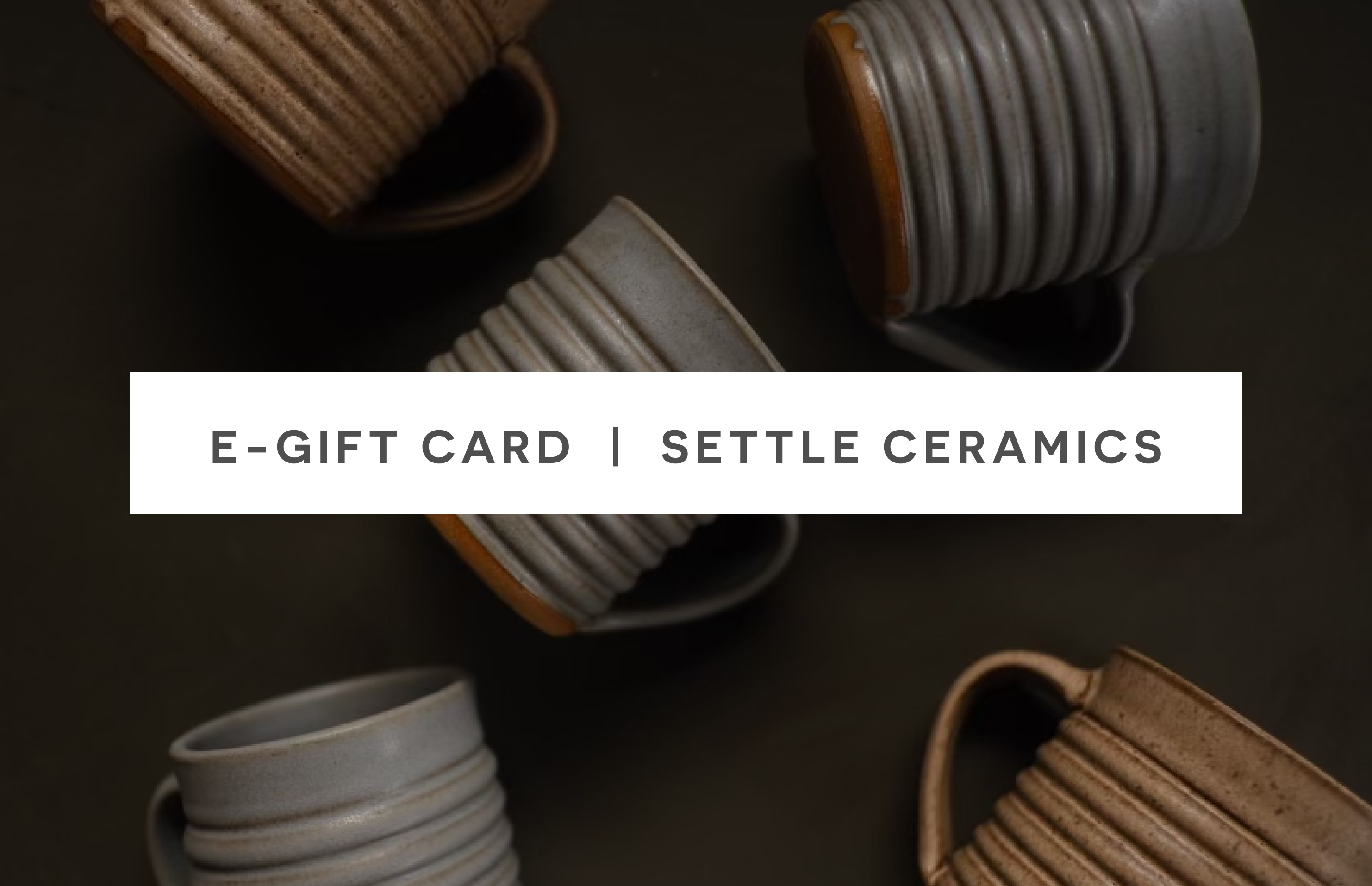 SETTLE eGift Card graphic over five ribbed ceramic mugs with raw clay bases arranged on a dark surface.