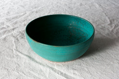 Wander Soup Bowl in bright teal matte glaze, angled view showing the smooth wide basin on linen cloth.