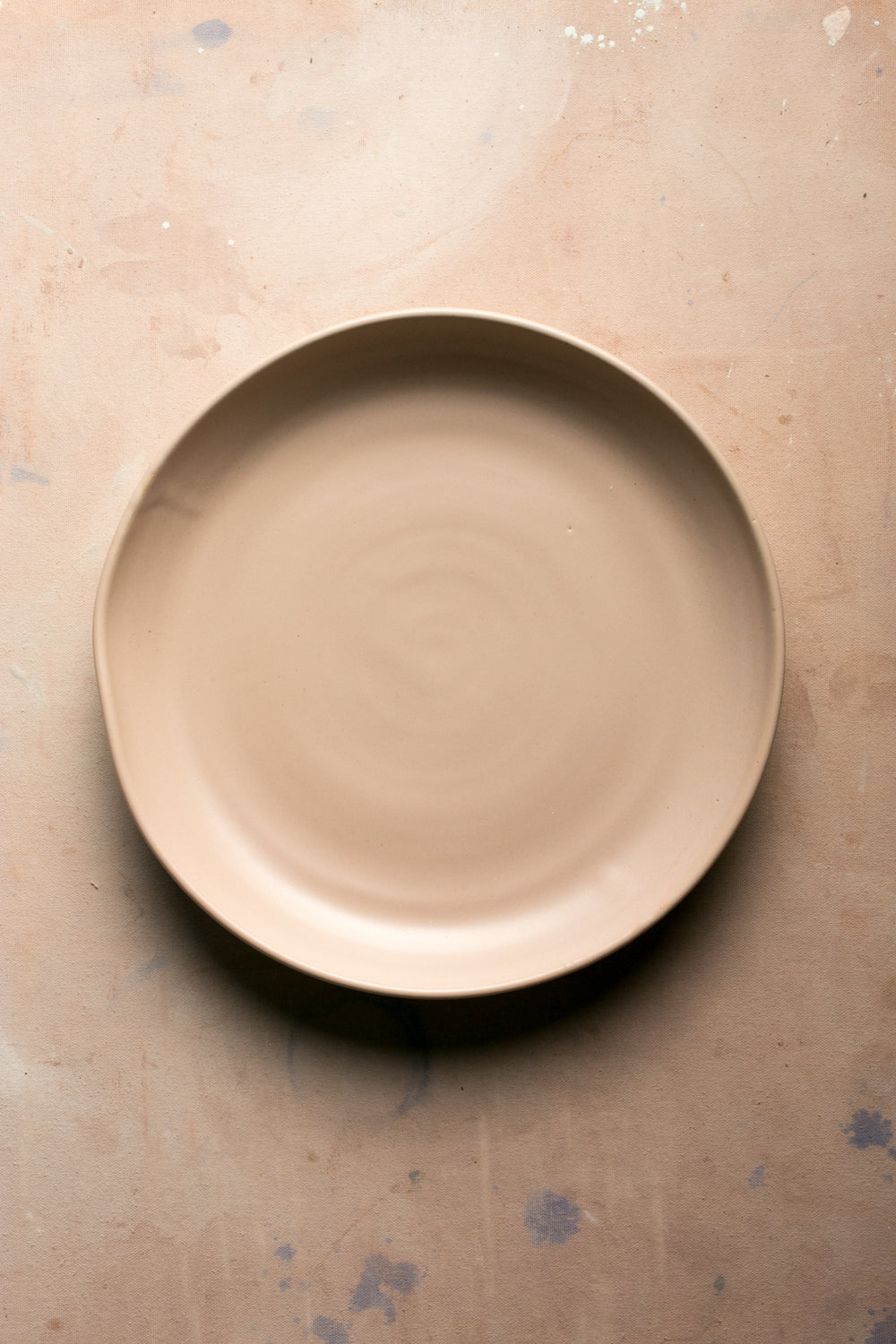 Wander Serving Platter in a smooth warm matte finish, viewed directly from above on a flat work table.